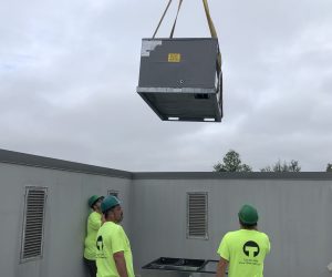 Team Mechanical - Technicians installing a new unit.